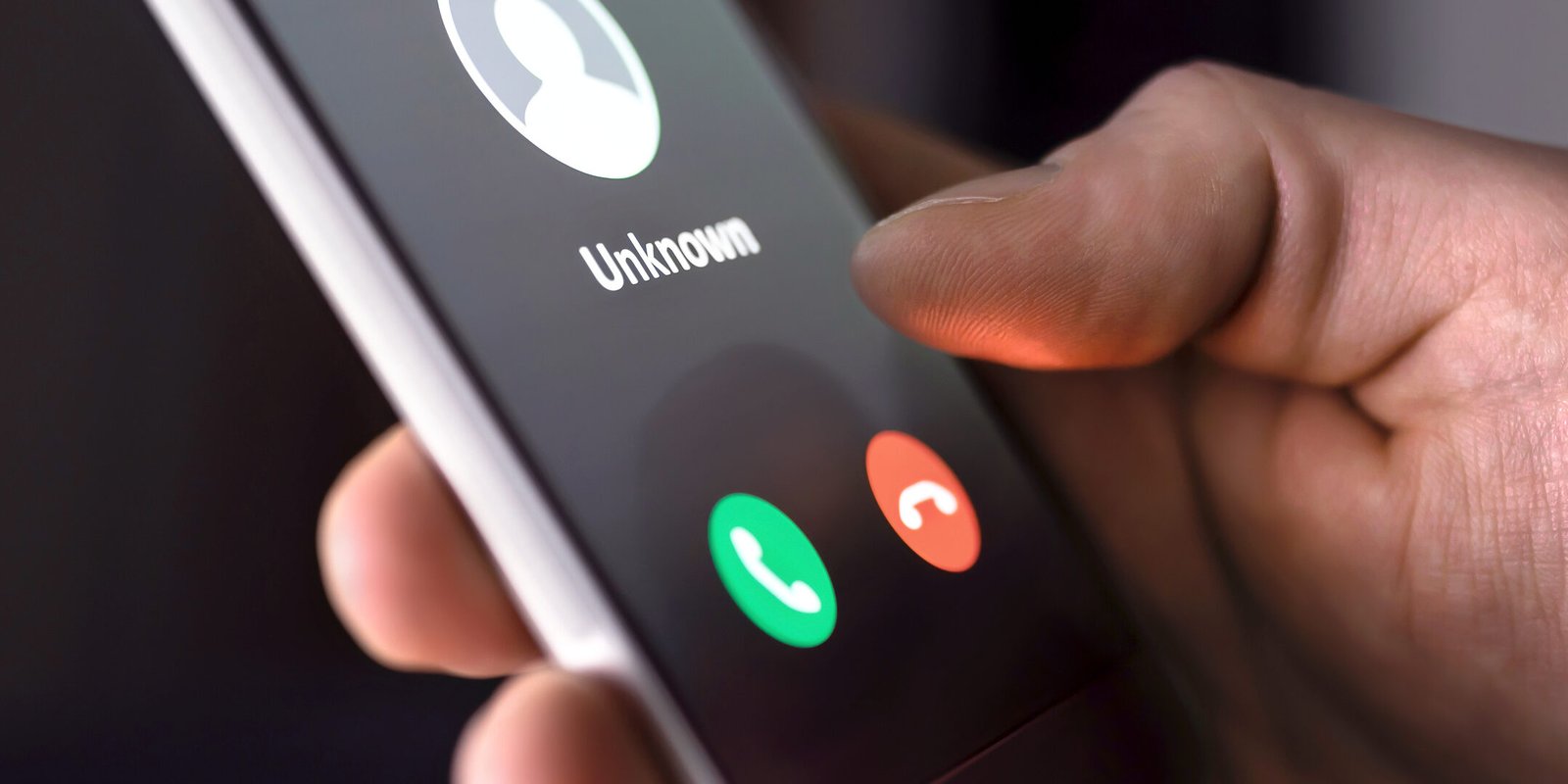 Phone call from unknown number late at night. Scam, fraud or phishing with smartphone concept. Prank caller, scammer or stranger. Man answering to incoming call